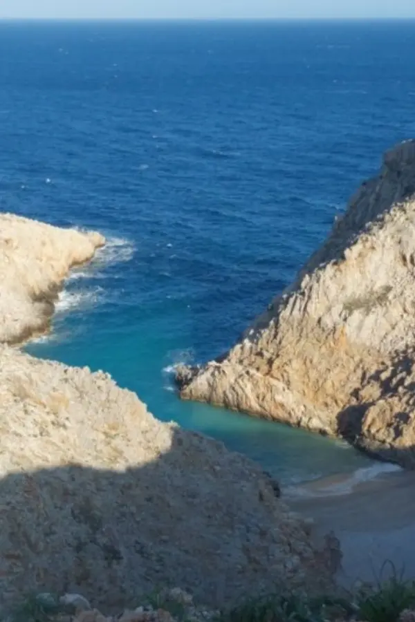 Rugged coastal landscape with deep blue waters and cliffs near Seitan Limania in Crete.